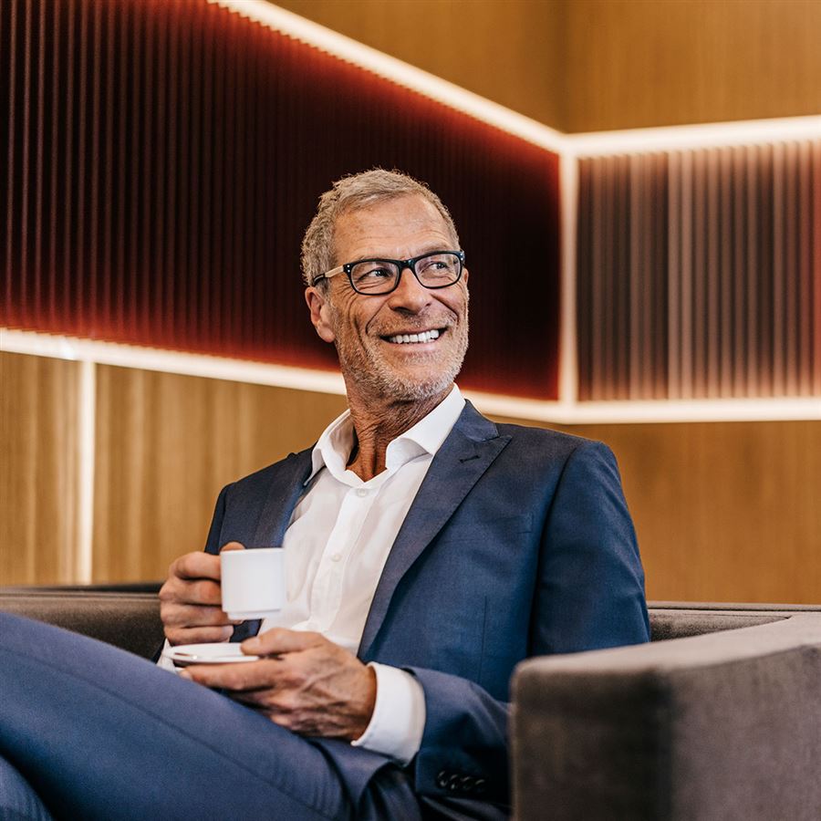 businessman drinking coffee in a chair