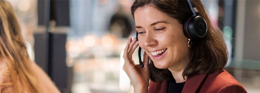 woman with a headset on working on the customer service